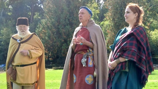 Three character actors dressed in Roman costume at Chedworth Roman Villa